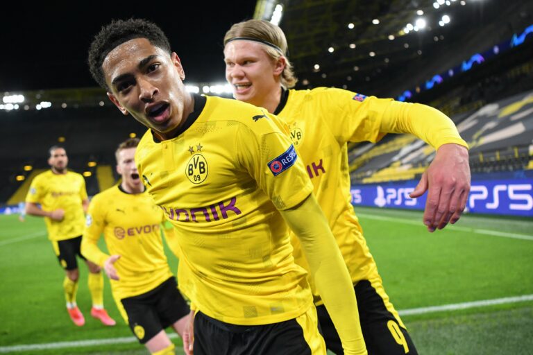 Dortmund's English midfielder Jude Bellingham (C) celebrates scoring the opening goal with his teammates including Dortmund's Norwegian forward Erling Braut Haaland (R) during the UEFA Champions League quarter-final second leg football match between BVB Borussia Dortmund and Manchester City in Dortmund, western Germany, on April 14, 2021. (Photo by INA FASSBENDER/AFP via Getty Images)