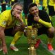 Dortmund's Norwegian forward Erling Braut Haaland (L) and Dortmund's English midfielder Jadon Sancho pose with the trophy after winning the German Cup (DFB Pokal) final