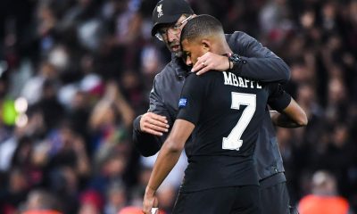 Jurgen Klopp coach of Liverpool talks to Kylian Mbappe of PSG during the Champions League match between Liverpool and Paris Saint Germain at Anfield on September 18, 2018 in Liverpool, England.