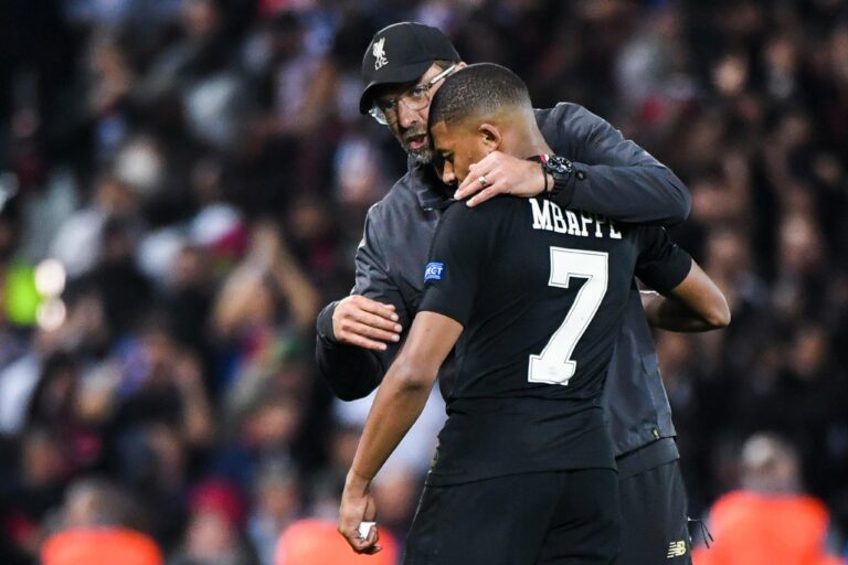 Jurgen Klopp coach of Liverpool talks to Kylian Mbappe of PSG during the Champions League match between Liverpool and Paris Saint Germain at Anfield on September 18, 2018 in Liverpool, England.