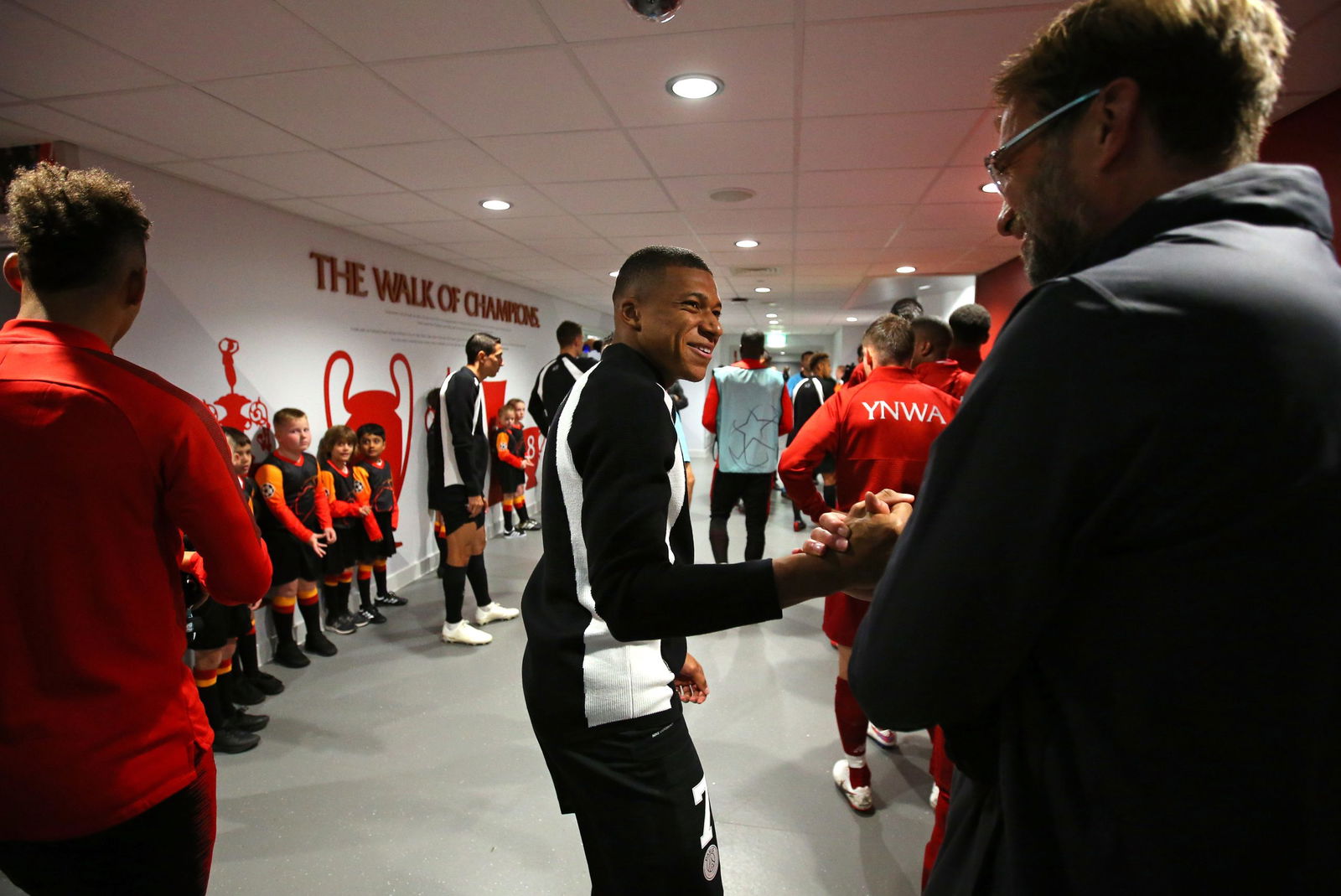 LIVERPOOL, ENGLAND - SEPTEMBER 18: Kylian Mbappe of Paris Saint-Germain shakes hands with Jurgen Klopp the manager of Liverpool in the tunnel prior to the Group C match of the UEFA Champions League between Liverpool and Paris Saint-Germain at Anfield on September 18, 2018 in Liverpool, United Kingdom.