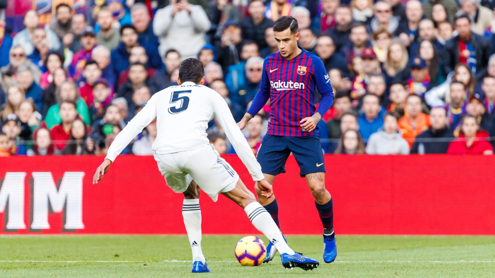 BARCELONA, SPAIN - OCTOBER 28: Coutinho of Barcelona and Raphael Varane of Real Madrid battle for the ball during the La Liga match between FC Barcelona and Real Madrid CF at Camp Nou on October 28, 2018 in Barcelona, Spain.