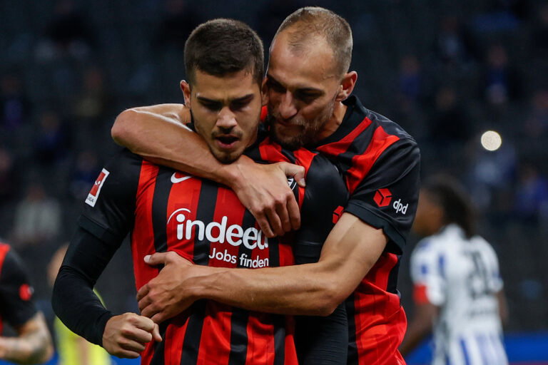 Frankfurt's Portuguese forward Andre Silva (C) celebrates scoring the opening goal from the penalty spot with his teammate Frankfurt's Dutch forward Bas Dost (R) during the German first division Bundesliga football match Hertha Berlin v Eintracht Frankfurt on September 25, 2020 in Berlin.