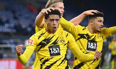 Dortmund's Norwegian forward Erling Braut Haaland (C) celebrates scoring the 4-0 goal with Dortmund's English midfielder Jude Bellingham (L) and Dortmund's English midfielder Jadon Sancho during the German first division Bundesliga football match FC Schalke 04 vs Borussia Dortmund in Gelsenkirchen, western Germany, on February 20, 2021.