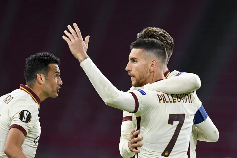Roma's Italian midfielder Lorenzo Pellegrini (R) celebrates with teammates after scoring a goal during the UEFA Europa League quarter-final football match between Ajax Amsterdam and AS Roma at the Johan Cruijff Arena in Amsterdam on April 8, 2021.