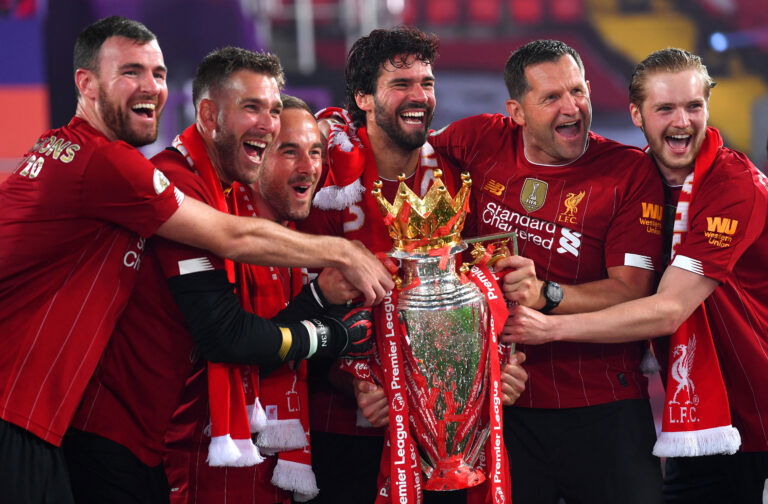 LIVERPOOL, ENGLAND - JULY 22: (L-R) Andy Lonergan, Adrian, Jack Robinson, Assistant Goalkeeping Coach, Alisson Becker, John Achterberg, Goalkeeping Coach and Caoimhin Kelleher of Liverpool celebrate with The Premier League trophy following the Premier League match between Liverpool FC and Chelsea FC at Anfield on July 22, 2020 in Liverpool, England.