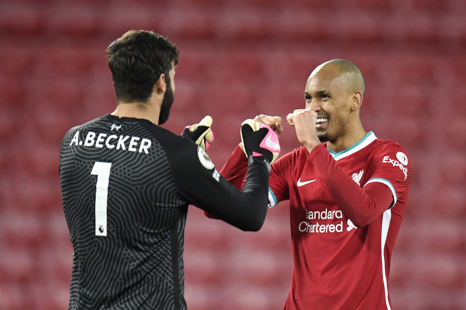 LIVERPOOL, ENGLAND - DECEMBER 16: Alisson Becker of Liverpool celebrates with Fabinho after the Premier League match between Liverpool and Tottenham Hotspur at Anfield on December 16, 2020 in Liverpool, England.