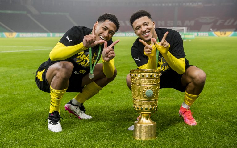 BERLIN, GERMANY - MAY 13: Jude Bellingham (L) and Jadon Sancho (R) of Borussia Dortmund celebrates after the DFB Cup final match between RB Leipzig and Borussia Dortmund at Olympic Stadium on May 13, 2021 in Berlin, Germany.