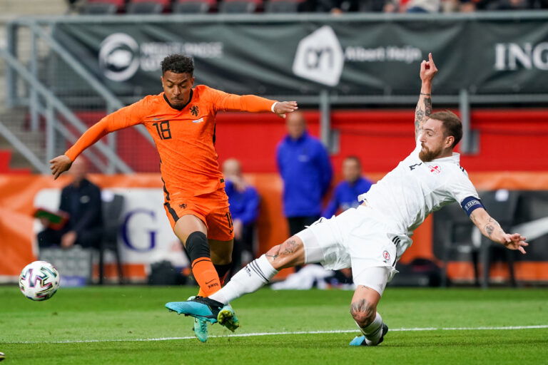 ENSCHEDE, NETHERLANDS - JUNE 6: Donyell Malen of the Netherlands and Guram Kashia of Georgia during the International Friendly match between Netherlands and Georgia at FC Twente Stadion on June 6, 2021 in Enschede, Netherlands.