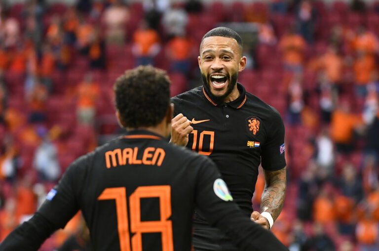 AMSTERDAM, NETHERLANDS - JUNE 21: Memphis Depay of Netherlands celebrates with teammate Donyell Malen after scoring their side's first goal during the UEFA Euro 2020 Championship Group C match between North Macedonia and The Netherlands at Johan Cruijff Arena on June 21, 2021 in Amsterdam, Netherlands.