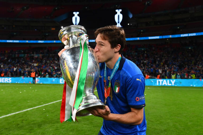 LONDON, ENGLAND - JULY 11: Federico Chiesa of Italy kisses The Henri Delaunay Trophy following his team's victory in the UEFA Euro 2020 Championship Final between Italy and England at Wembley Stadium on July 11, 2021 in London, England.