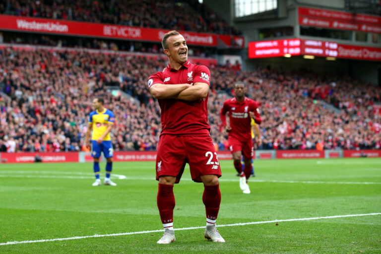 LIVERPOOL, ENGLAND - SEPTEMBER 22: Xherdan Shaqiri of Liverpool celebrates after he provides the assist for Liverpool's first goal, an own goal by Wesley Hoedt of Southampton during the Premier League match between Liverpool FC and Southampton FC at Anfield on September 22, 2018 in Liverpool, United Kingdom. (Photo by Alex Livesey/Getty Images)