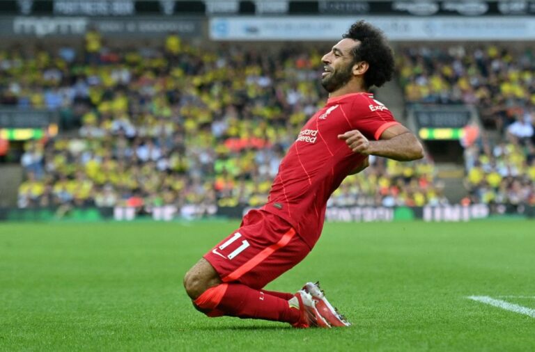 Liverpool's Egyptian midfielder Mohamed Salah celebrates scoring his team's third goal during the English Premier League football match between Norwich City and Liverpool at Carrow Road in Norwich, eastern England on August 14, 2021. - RESTRICTED TO EDITORIAL USE. No use with unauthorized audio, video, data, fixture lists, club/league logos or 'live' services. Online in-match use limited to 120 images. An additional 40 images may be used in extra time. No video emulation. Social media in-match use limited to 120 images. An additional 40 images may be used in extra time. No use in betting publications, games or single club/league/player publications. (Photo by JUSTIN TALLIS / AFP) / RESTRICTED TO EDITORIAL USE. No use with unauthorized audio, video, data, fixture lists, club/league logos or 'live' services. Online in-match use limited to 120 images. An additional 40 images may be used in extra time. No video emulation. Social media in-match use limited to 120 images. An additional 40 images may be used in extra time. No use in betting publications, games or single club/league/player publications. / RESTRICTED TO EDITORIAL USE. No use with unauthorized audio, video, data, fixture lists, club/league logos or 'live' services. Online in-match use limited to 120 images. An additional 40 images may be used in extra time. No video emulation. Social media in-match use limited to 120 images. An additional 40 images may be used in extra time. No use in betting publications, games or single club/league/player publications. (Photo by JUSTIN TALLIS/AFP via Getty Images)