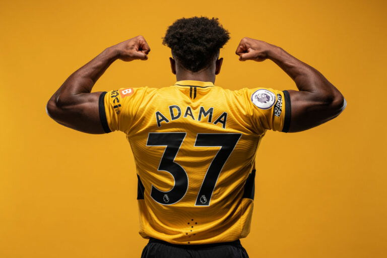 WOLVERHAMPTON, ENGLAND - AUGUST 03: Adama Traore of Wolverhampton Wanderers poses for a portrait in the Wolverhampton Wanderers 2021/22 Home Kit at Molineux on August 03, 2021 in Wolverhampton, England. (Photo by Wolverhampton Wanderers FC/Wolves via Getty Images)