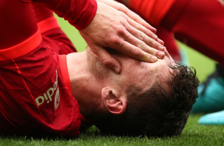 LIVERPOOL, ENGLAND - AUGUST 08: Andy Robertson of Liverpool reacts after an injury during the pre-season friendly match between Liverpool and Athletic Club at Anfield on August 08, 2021 in Liverpool, England. (Photo by Jan Kruger/Getty Images,)