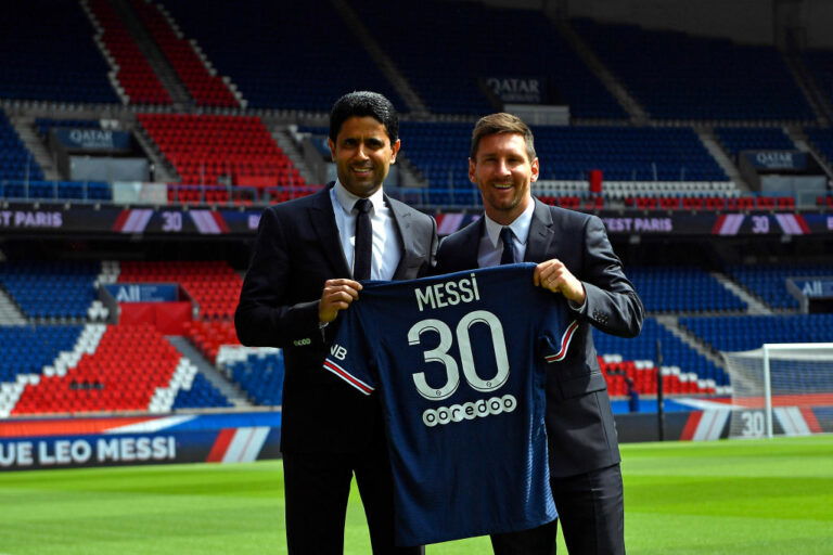 PARIS, FRANCE - AUGUST 11: Lionel Messi poses with his jersey next to President Nasser Al Khelaifi after the press conference of Paris Saint-Germain at Parc des Princes on August 11, 2021 in Paris, France. (Photo by Aurelien Meunier - PSG/PSG via Getty Images)