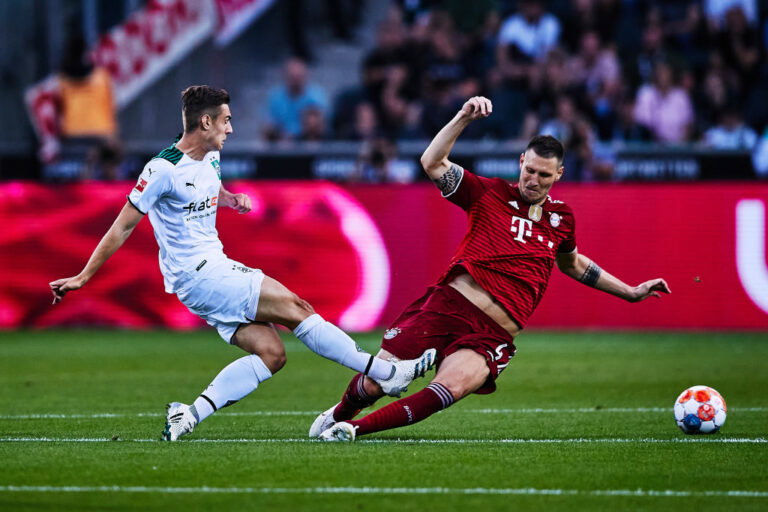 MOENCHENGLADBACH, GERMANY - AUGUST 13: Florian Neuhaus of Borussia Mönchengladbach competes with Niklas Süle FC Bayern during the Bundesliga match between Borussia Mönchengladbach and FC Bayern München at Borussia-Park on August 13, 2021 in Moenchengladbach, Germany. (Photo by Joosep Martinson/Getty Images,)