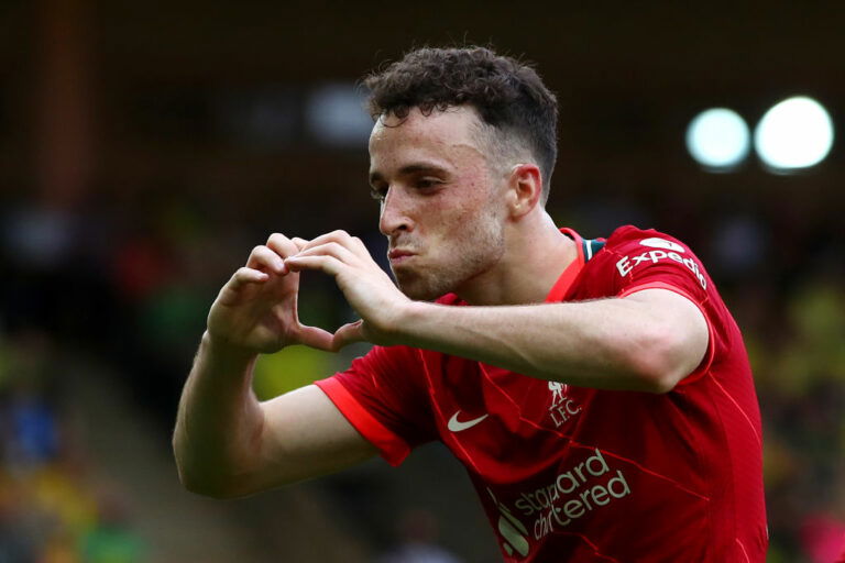 NORWICH, ENGLAND - AUGUST 14: Diogo Jota of Liverpool celebrates after scoring their side's first goal during the Premier League match between Norwich City and Liverpool at Carrow Road on August 14, 2021 in Norwich, England. (Photo by Marc Atkins/Getty Images)