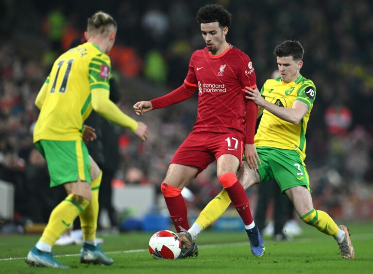 Norwich City's Polish midfielder Przemyslaw Placheta (L) an Norwich City's English defender Sam Byram (R) vie with Liverpool's English midfielder Curtis Jones during the English FA Cup fifth round football match between Liverpool and Norwich City at Anfield in Liverpool, north west England on March 2, 2022. - - RESTRICTED TO EDITORIAL USE. No use with unauthorized audio, video, data, fixture lists, club/league logos or 'live' services. Online in-match use limited to 120 images. An additional 40 images may be used in extra time. No video emulation. Social media in-match use limited to 120 images. An additional 40 images may be used in extra time. No use in betting publications, games or single club/league/player publications. (Photo by Paul ELLIS / AFP) / RESTRICTED TO EDITORIAL USE. No use with unauthorized audio, video, data, fixture lists, club/league logos or 'live' services. Online in-match use limited to 120 images. An additional 40 images may be used in extra time. No video emulation. Social media in-match use limited to 120 images. An additional 40 images may be used in extra time. No use in betting publications, games or single club/league/player publications. / RESTRICTED TO EDITORIAL USE. No use with unauthorized audio, video, data, fixture lists, club/league logos or 'live' services. Online in-match use limited to 120 images. An additional 40 images may be used in extra time. No video emulation. Social media in-match use limited to 120 images. An additional 40 images may be used in extra time. No use in betting publications, games or single club/league/player publications. (Photo by PAUL ELLIS/AFP via Getty Images)