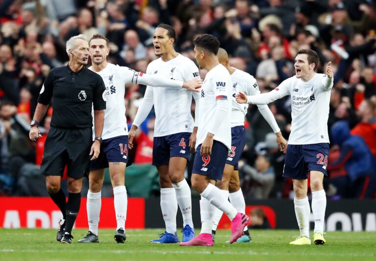 Martin Atkinson and Liverpool players at Old Trafford, manchester United in 2019