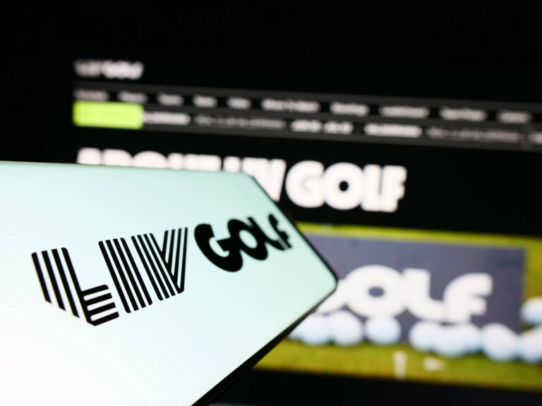 Cellphone with logo of sports organization LIV Golf on screen in front of website. Stuttgart, Germany - 06-17-2023: Cell